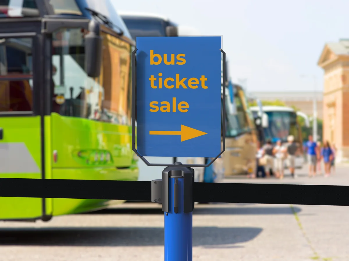 Blue belt barrier post with a sign holder at a bus station